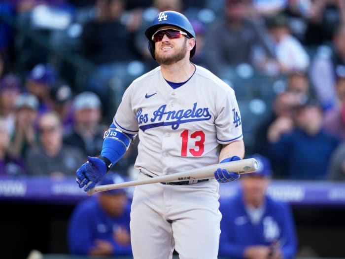 Los Angeles Dodgers’ Max Muncy reacts after striking out against Colorado Rockies relief pitcher Justin Lawrence in the ninth inning of a baseball game Friday, April 8, 2022, in Denver.